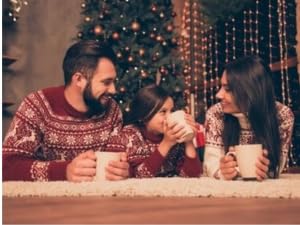 ICMinds Stores luxury hot chocolate gift set enjoyed by a family in matching festive sweaters by a Christmas tree
